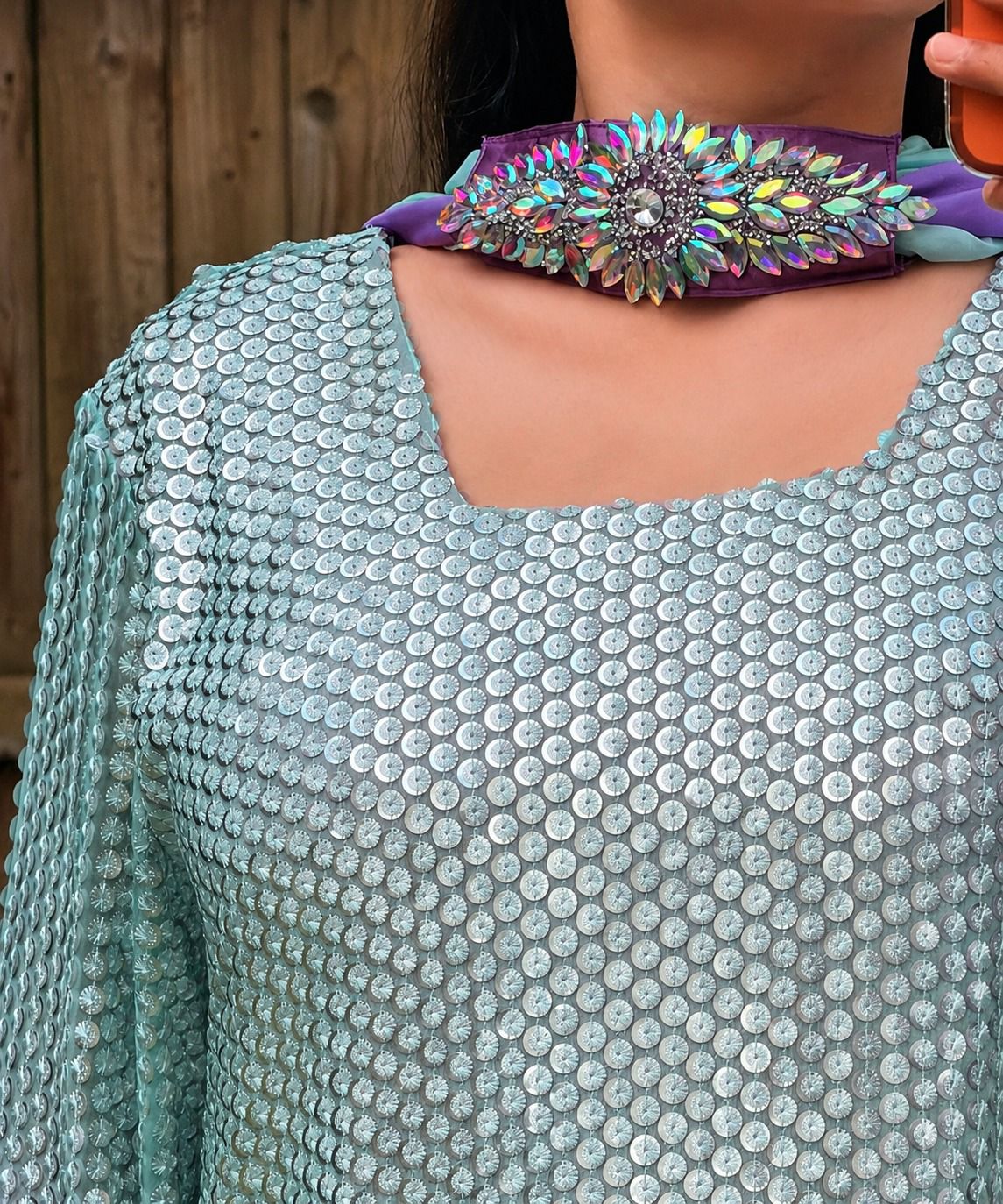 Woman wearing mint green sequin Pakistani suit with lavender trousers and pastel dupatta in elegant festive ethnic style.