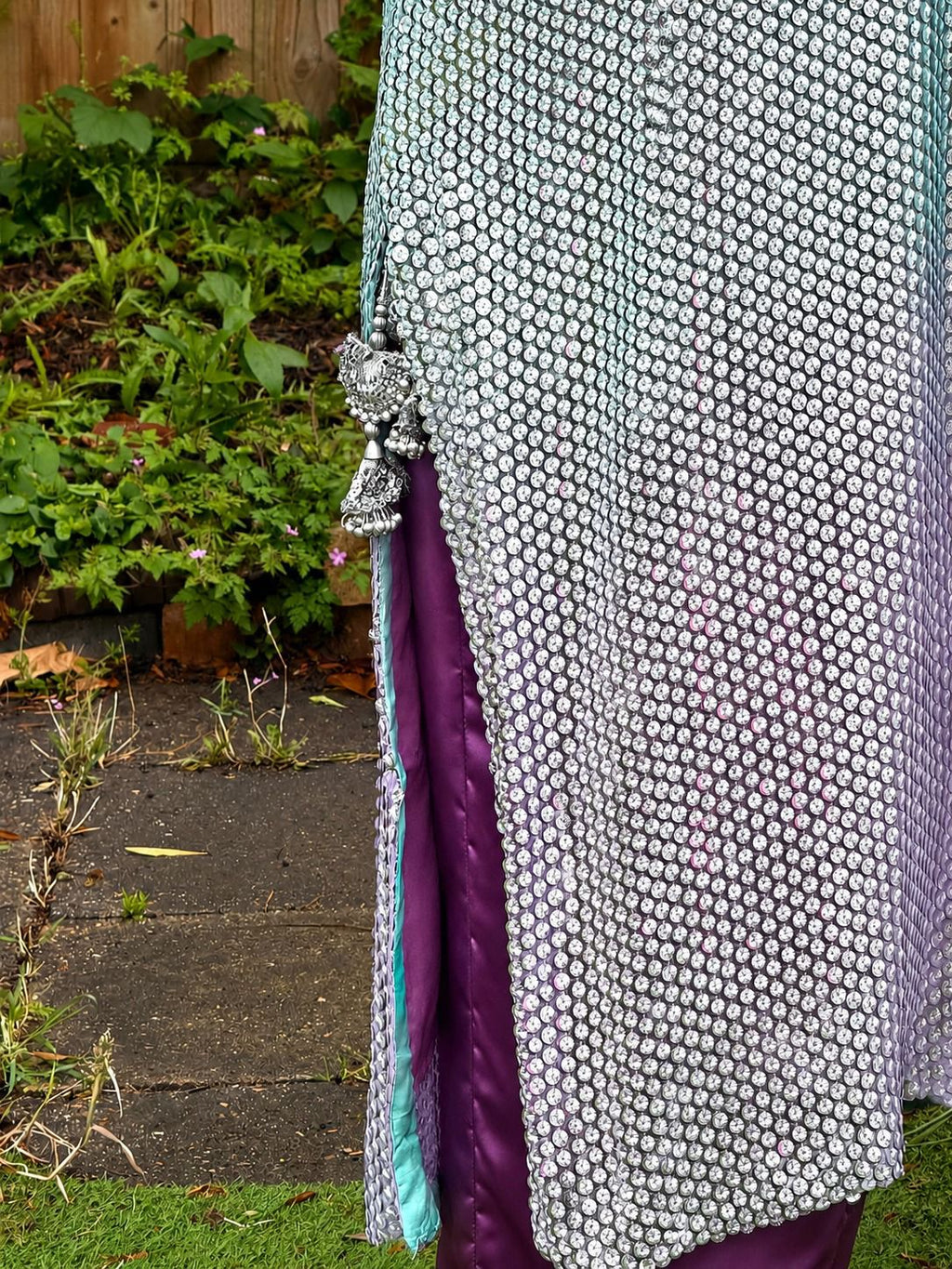 Woman wearing mint green sequin Pakistani suit with lavender trousers and pastel dupatta in elegant festive ethnic style.