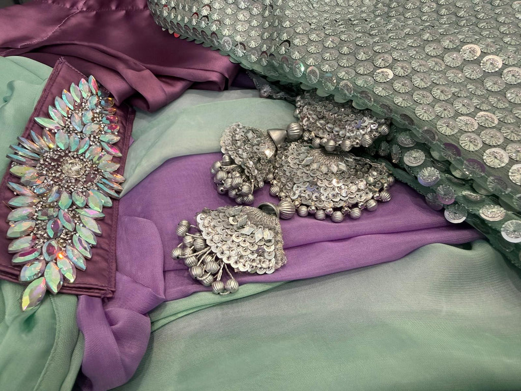 Woman wearing mint green sequin Pakistani suit with lavender trousers and pastel dupatta in elegant festive ethnic style.
